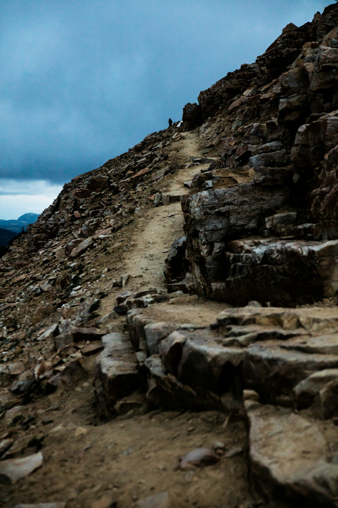person hiking mountain trail